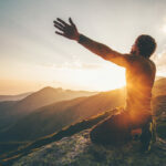 Man,Praying,At,Sunset,Mountains,Raised,Hands,Travel,Lifestyle,Spiritual